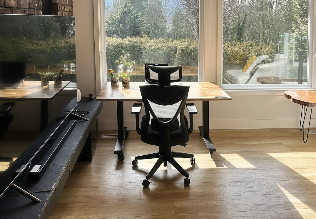 Laptop with source code on a desk in a bright office