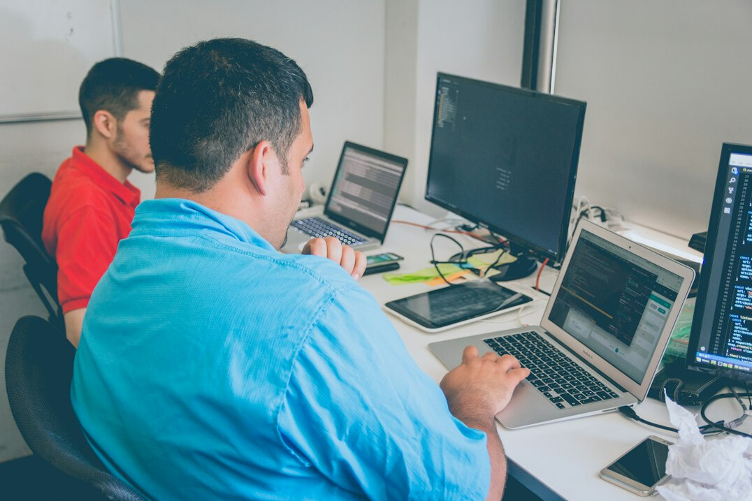 team of programmers working on code
